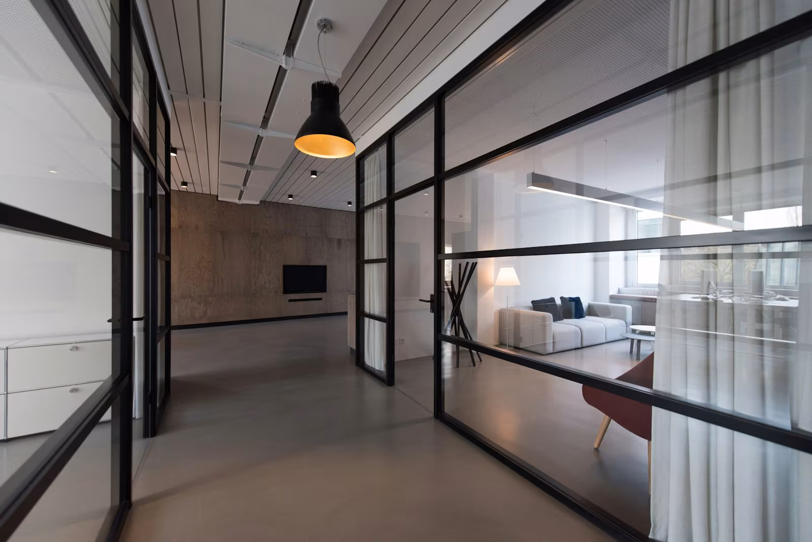 Frameless glass partitions dividing a bright office