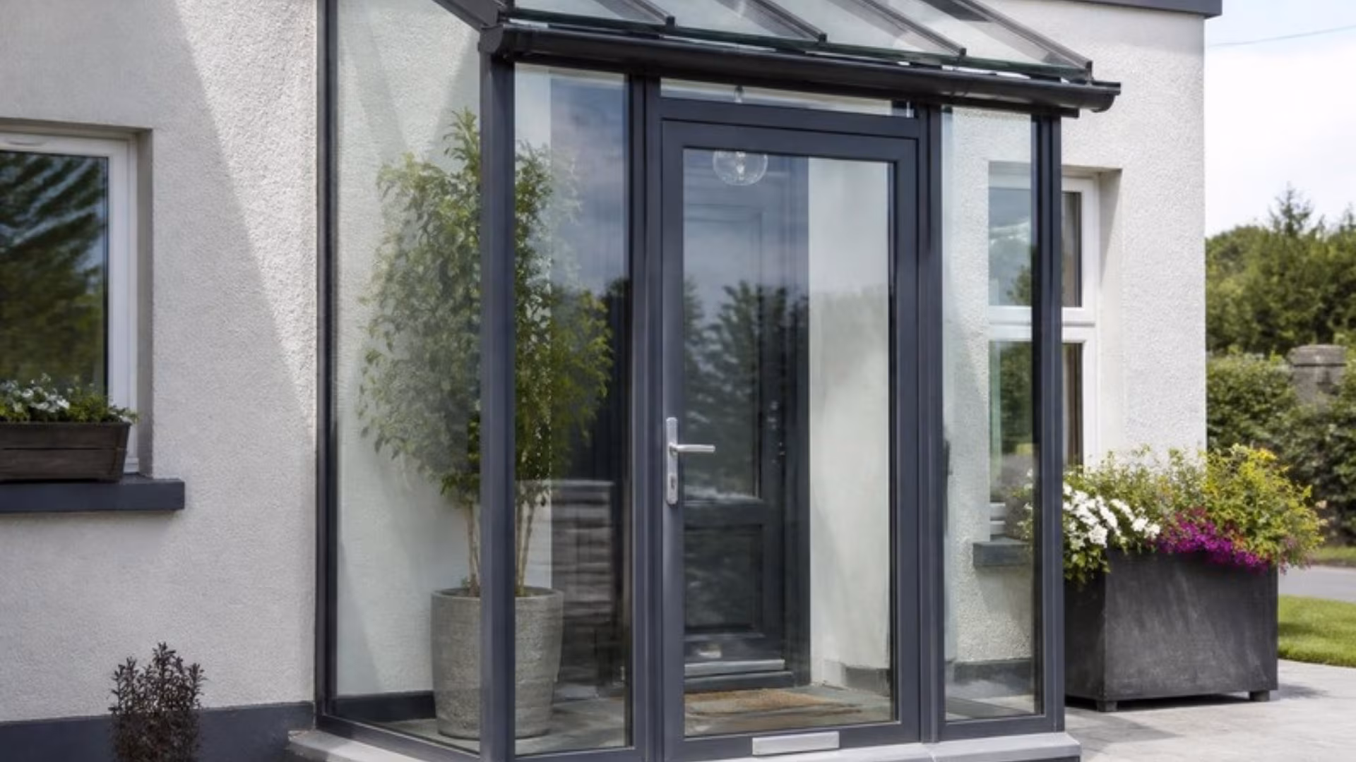 Aluminium framed glass porch at the front door of a house
