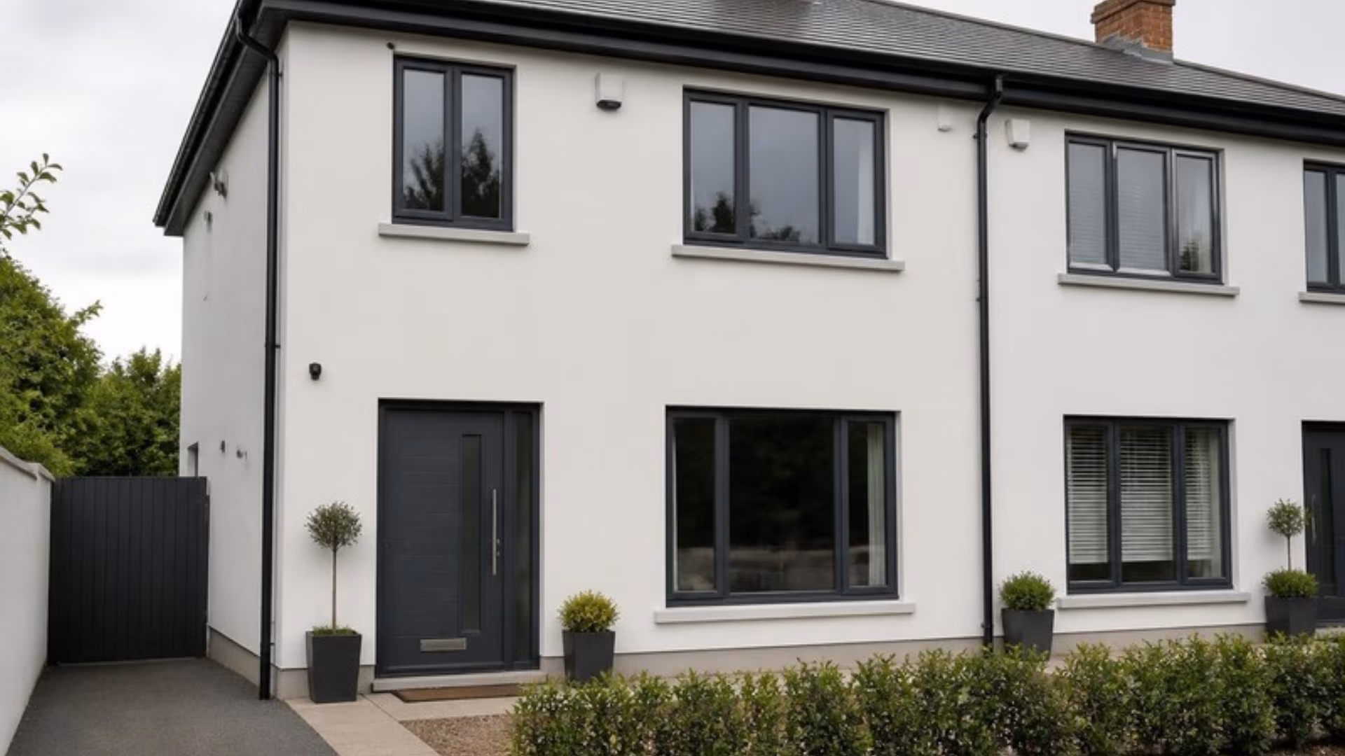 Semi-detached house with anthracite grey aluminium windows and front door