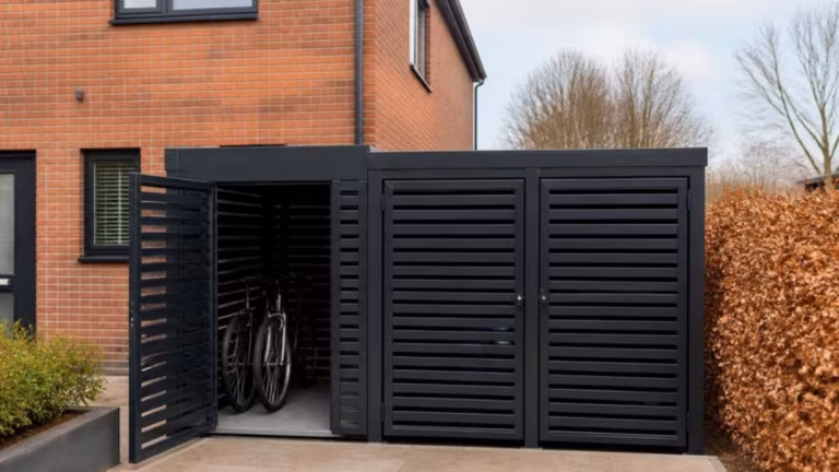 Combined aluminium bin store and bike store beside a house