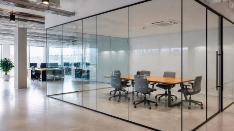 Glass-walled meeting room with a frosted manifestation band