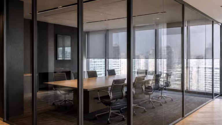 Meeting room enclosed with grey tinted glass