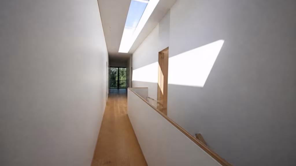 Narrow linear rooflight lighting a hallway in a modern house