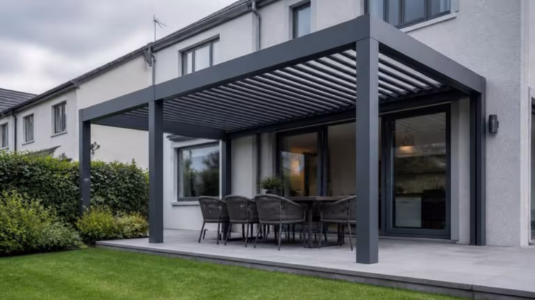 Anthracite aluminium louvred pergola over a patio at the back of a house