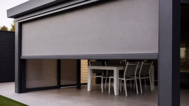 Zip screen blind half lowered on the side of a pergola