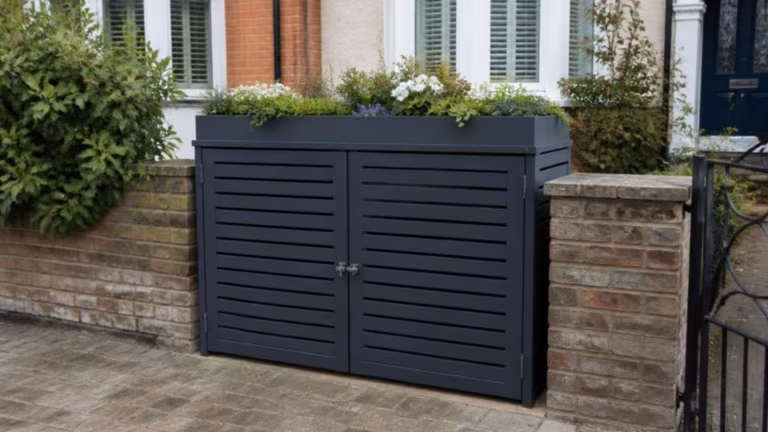 Two-bin aluminium store with a planter lid in a front garden